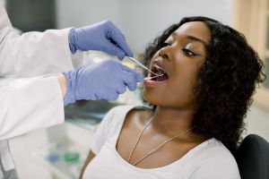 A dentist checks a patient's dental implant.